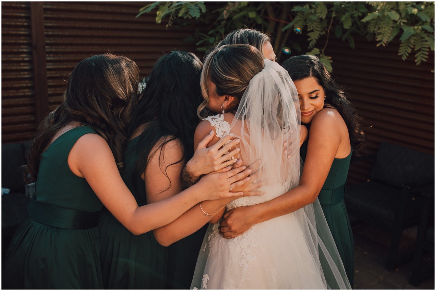 bride hugging her bridesmaids