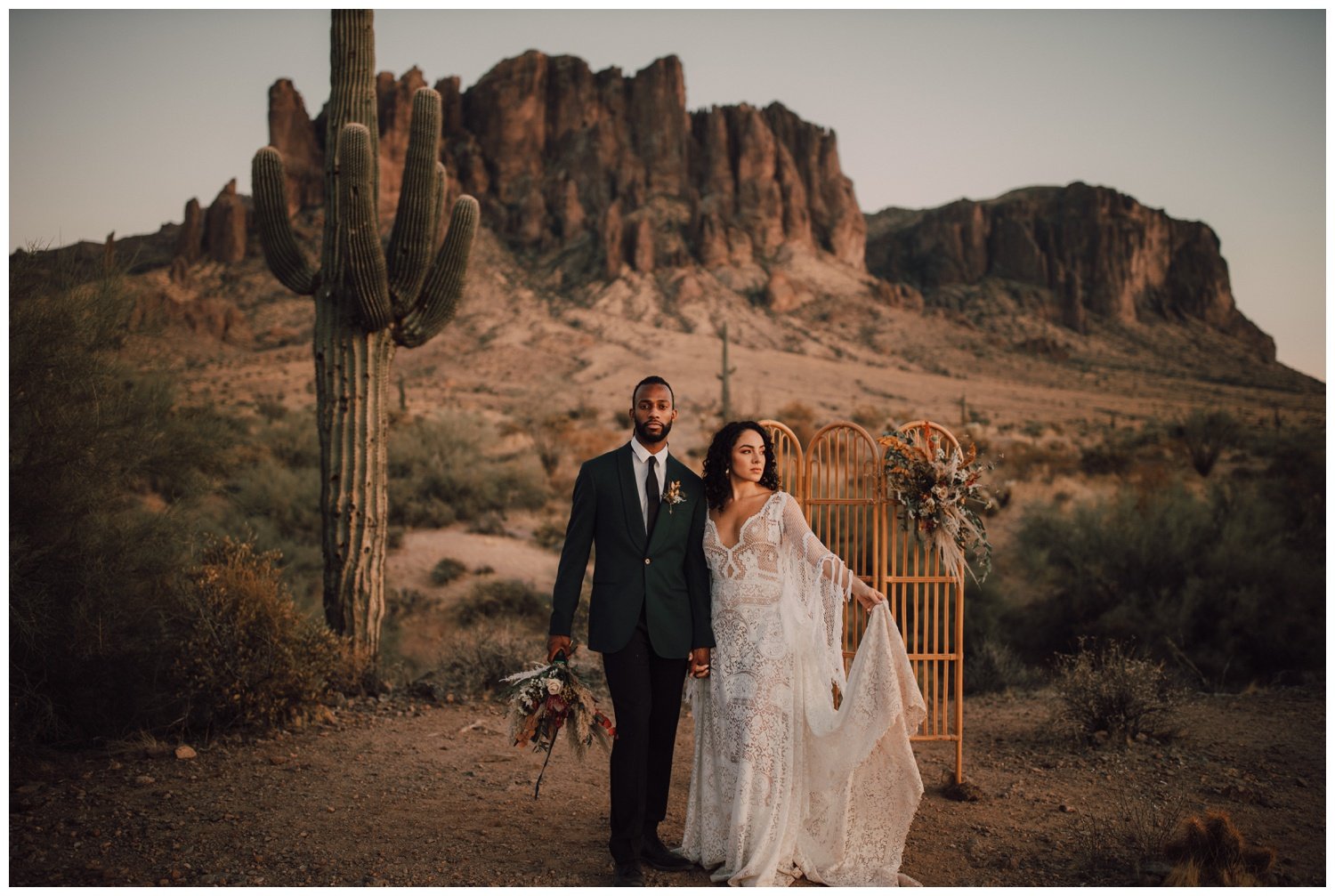 Bride and groom posing at golden hour at the superstition mountains
