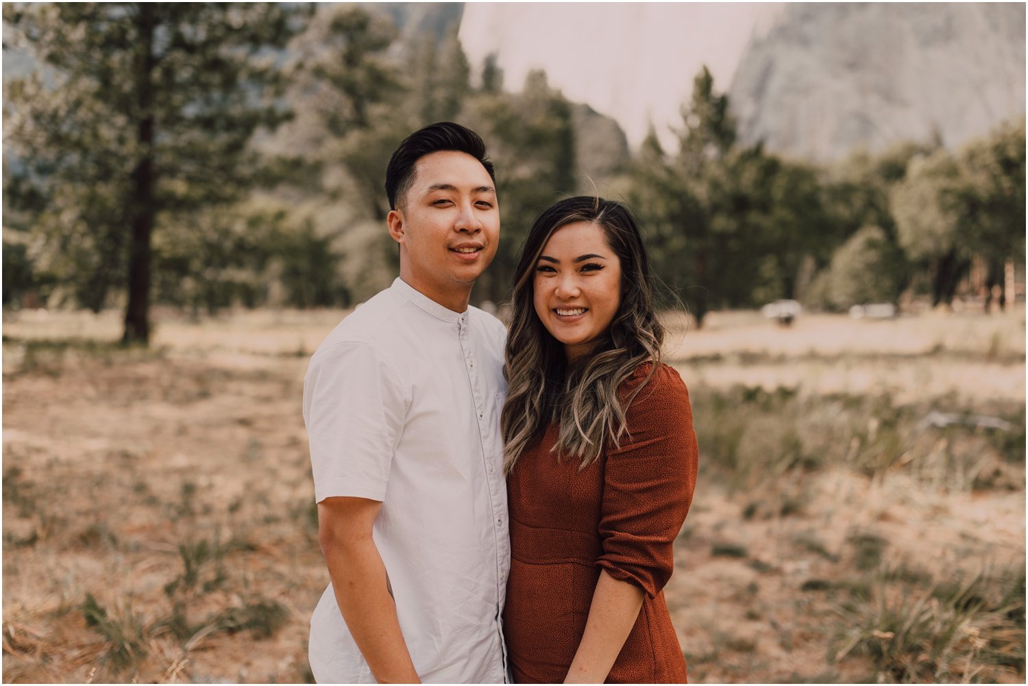 engaged couple taking portraits in El Capitan meadow in Yosemite national park 
