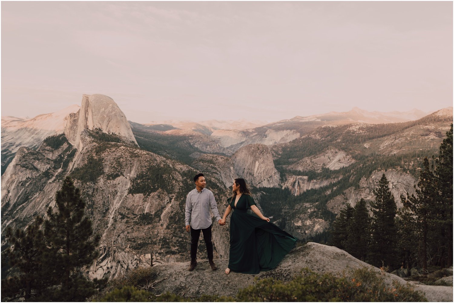 engaged couple taking portraits on a mountain top in Yosemite national park 
