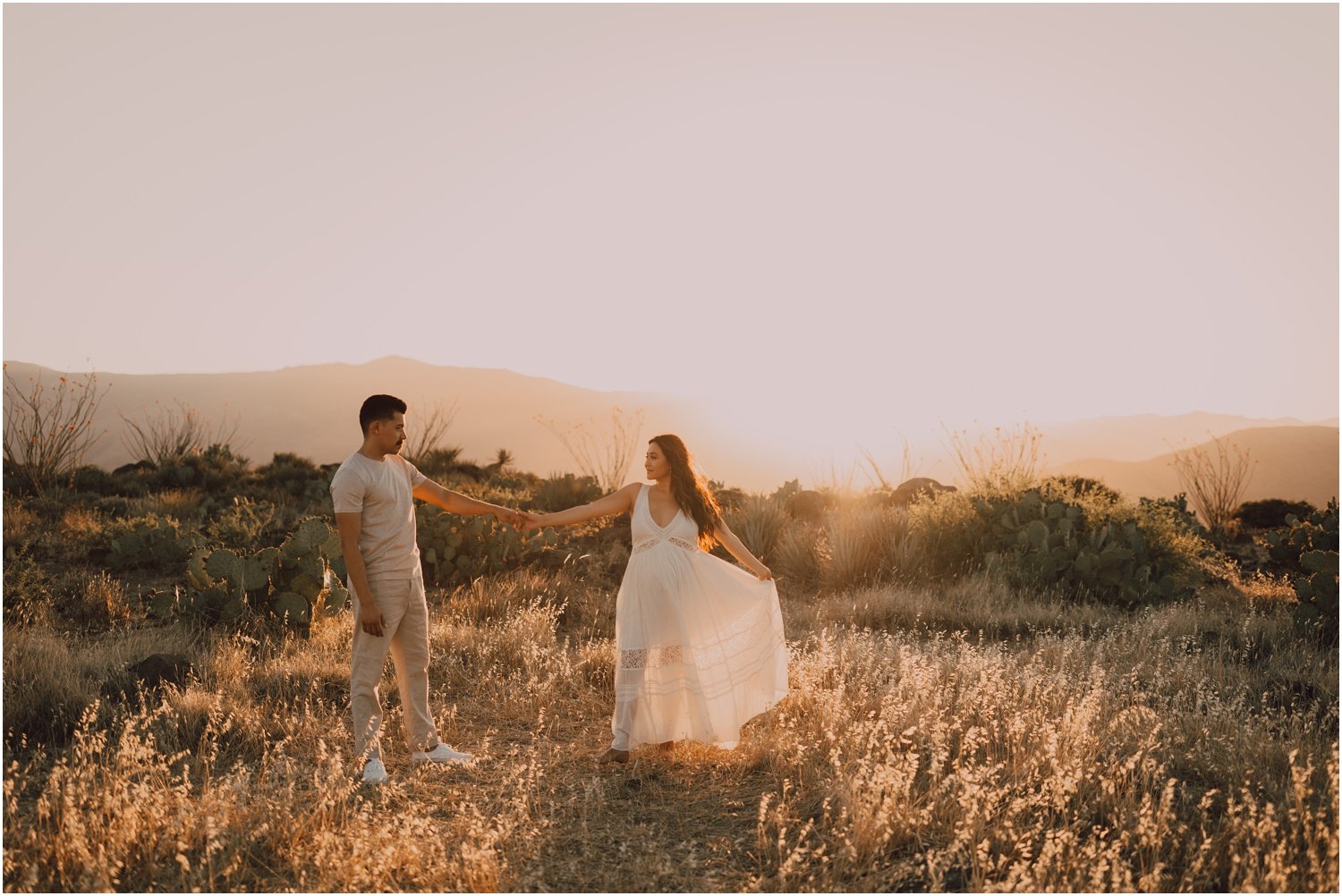 sunset maternity photos with married couple in the desert