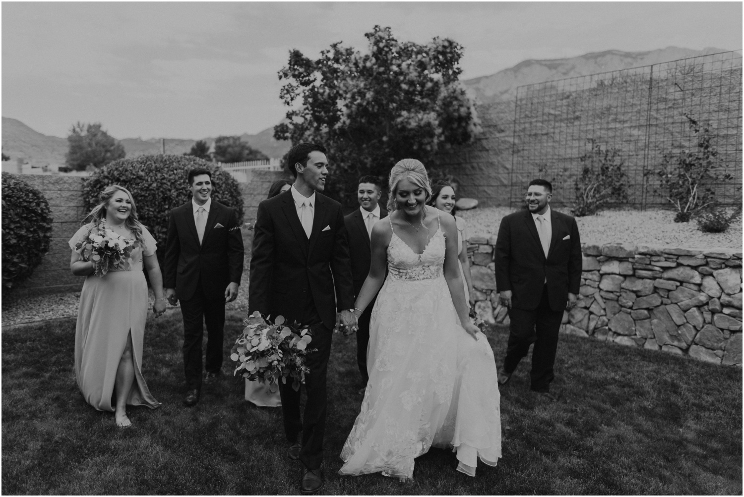 black and white photo of bride and groom with their wedding party
