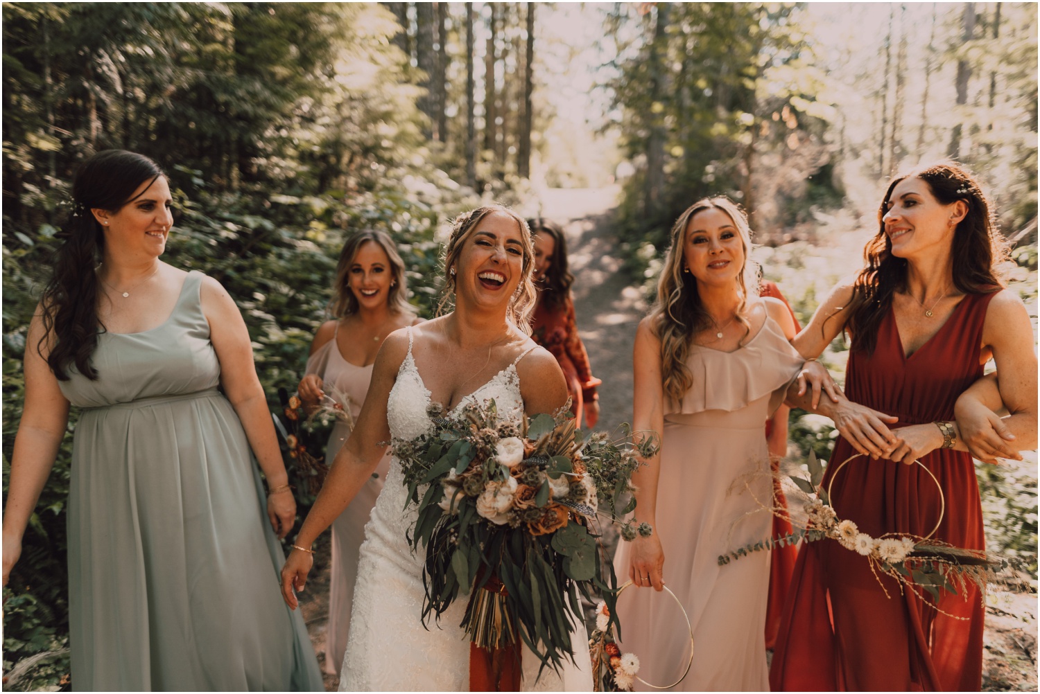 bride walking through the forest with her bridesmaids