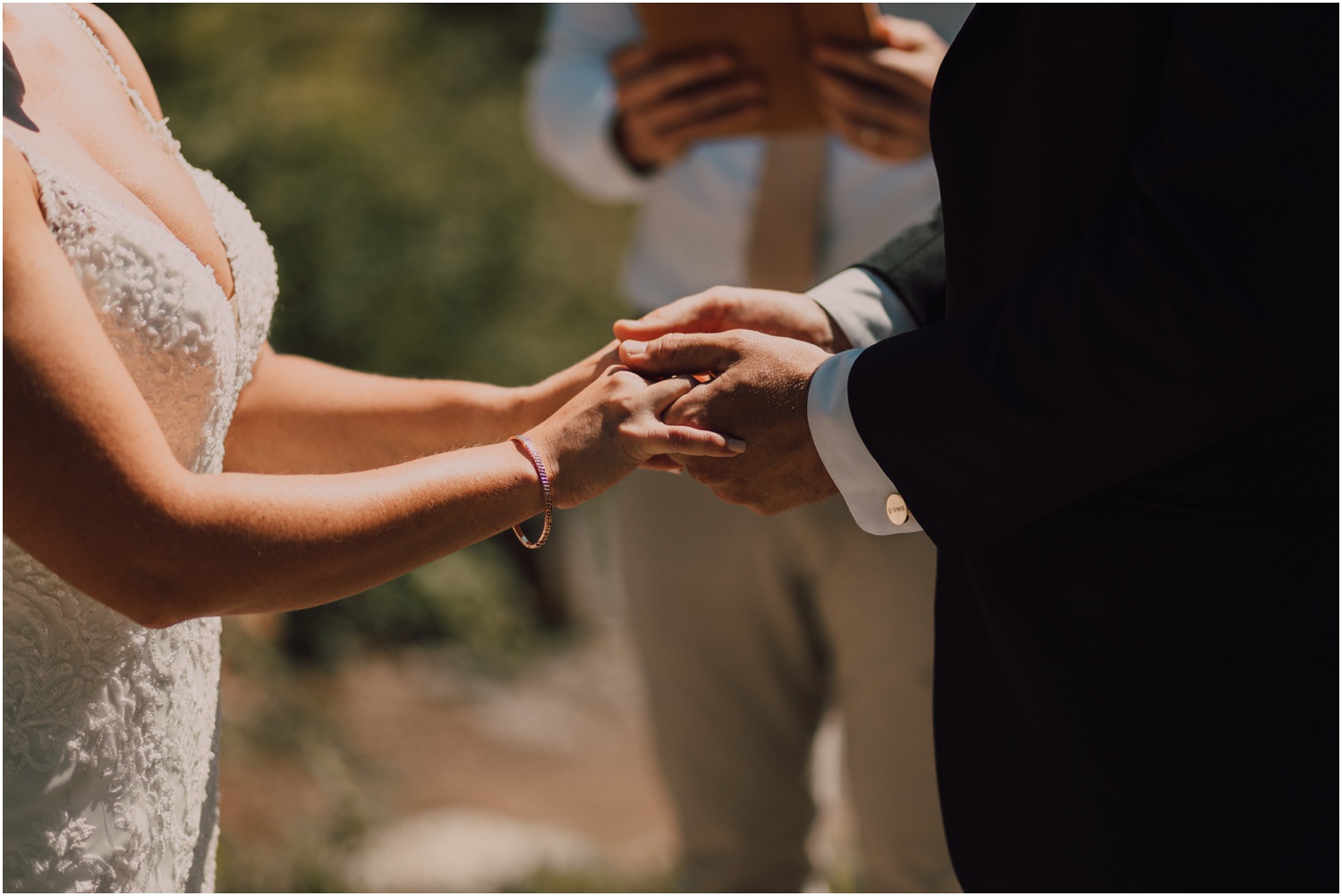 Bride and groom holding hands while exchanging vows for their adventure elopement