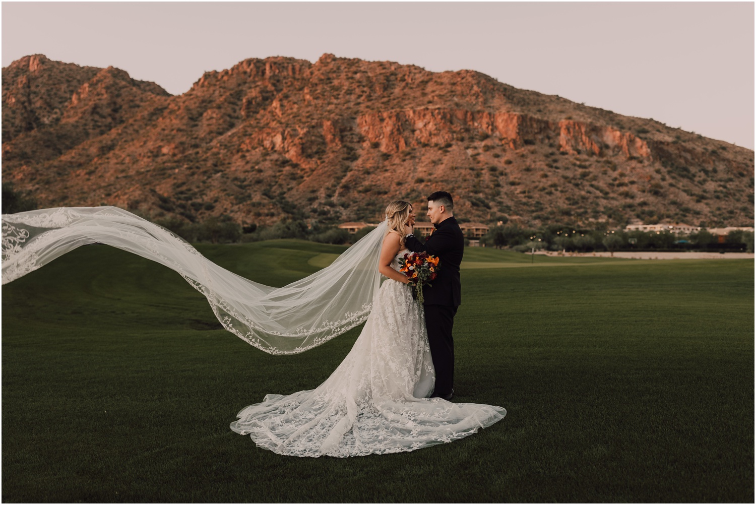 bride and groom portraits in front of the arizona mountains for their wedding at the phoenician