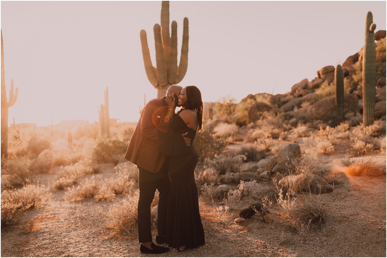 engaged couple taking portraits in the arizona desert during golden hour