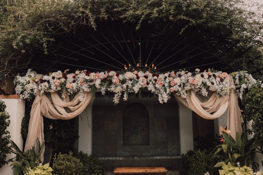 wedding ceremony arch at Stillwell House in Tucson, captured by Riss and Steven Photography