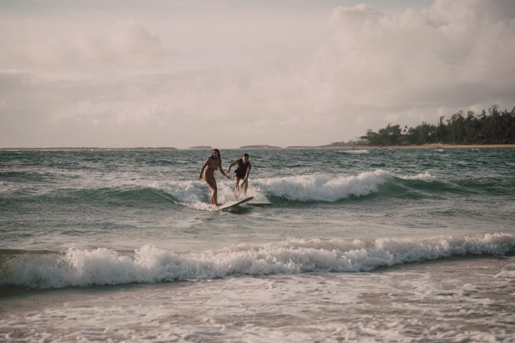 surfing couples session on Oahu, Hawaii. Captured by Riss and Steven Photography