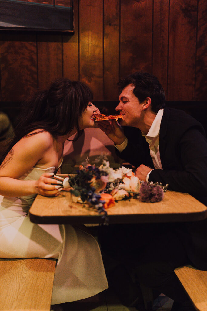 Couple eating Scarrs Pizza in New York City 