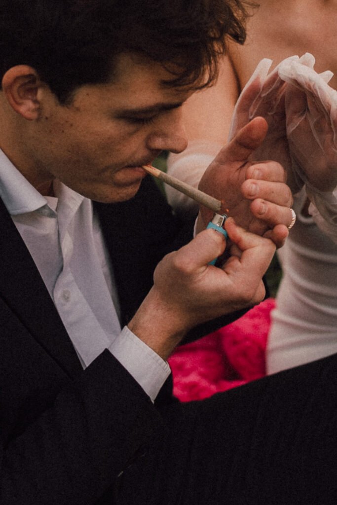 Wedding portraits at Brooklyn Bridge Park smoking a joint 