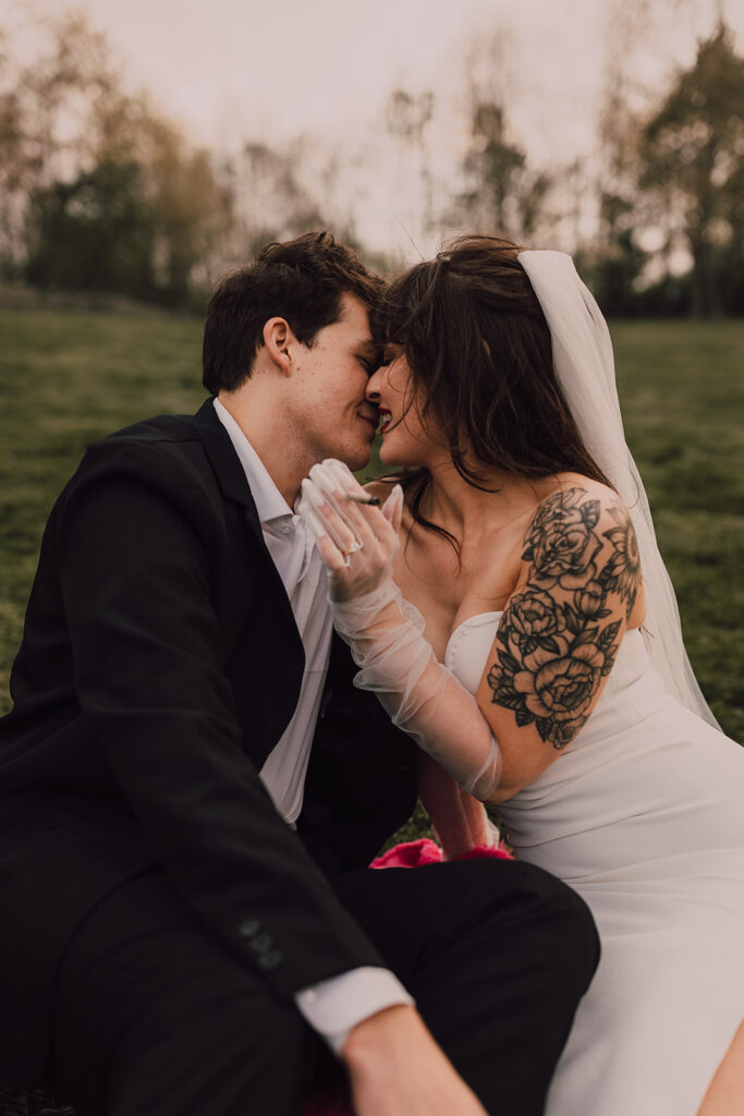 Couple kissing in Brooklyn Bridge Park smoking a joint 