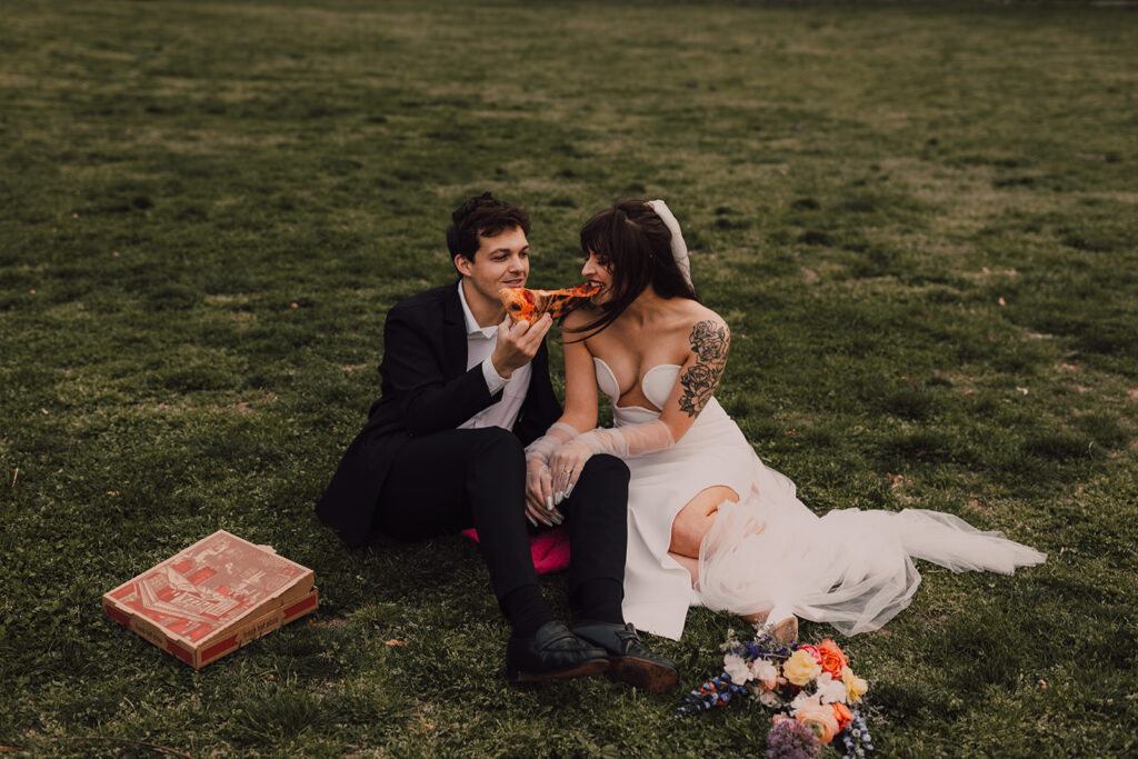 Couple kissing in Brooklyn Bridge Park smoking a joint 