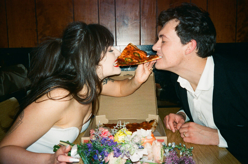 Couple eating Scarrs Pizza in New York City 