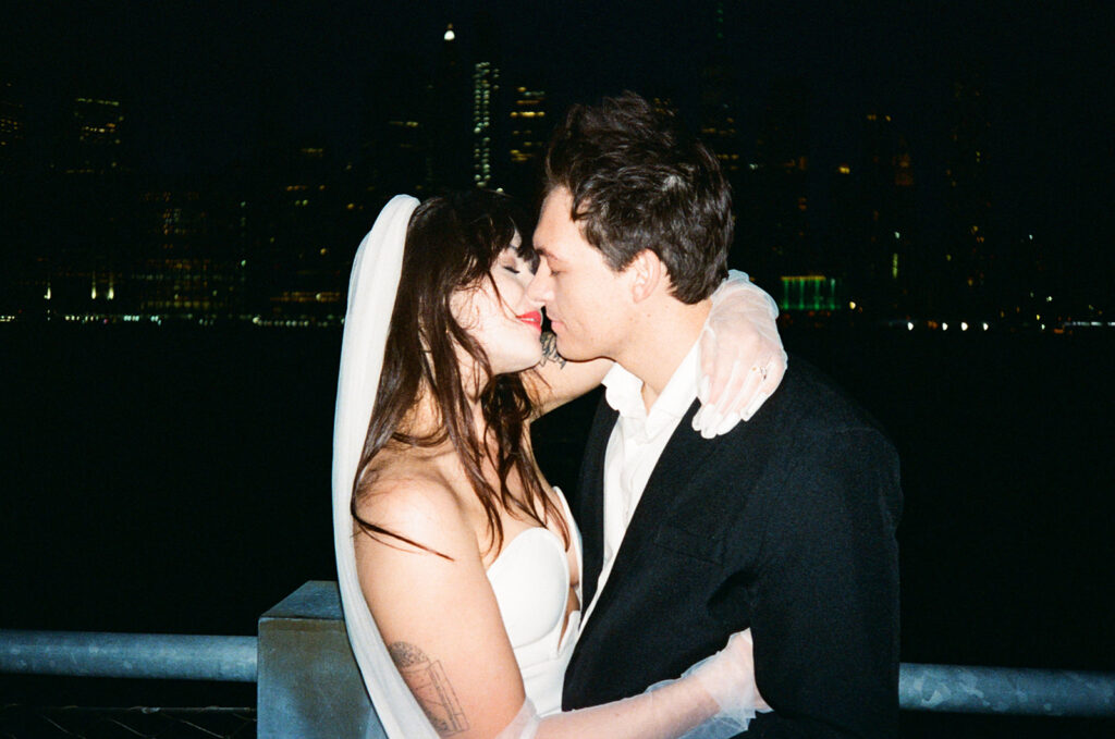 Couple kissing with NYC skyline in the back