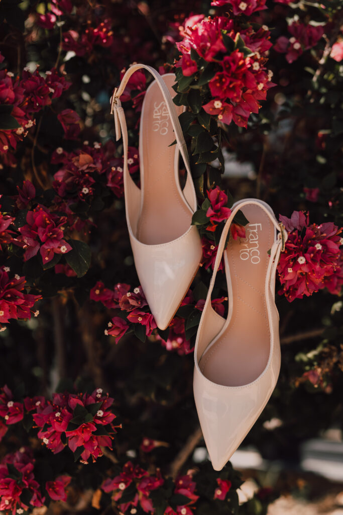 bridal shoes hanging from a pink Bougainvillea tree