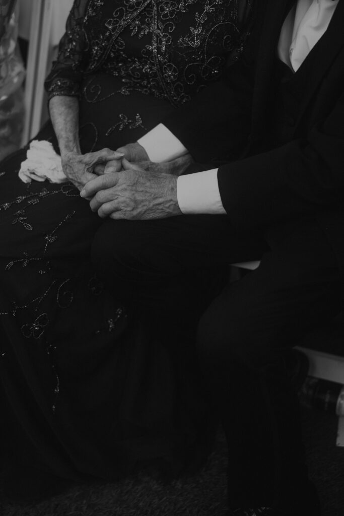 grandma and grandpa holding hands at a wedding, old lady and man holding hands, black and white photography