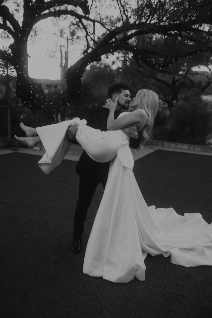 black and white wedding portraits, groom holding bride, bride and groom 