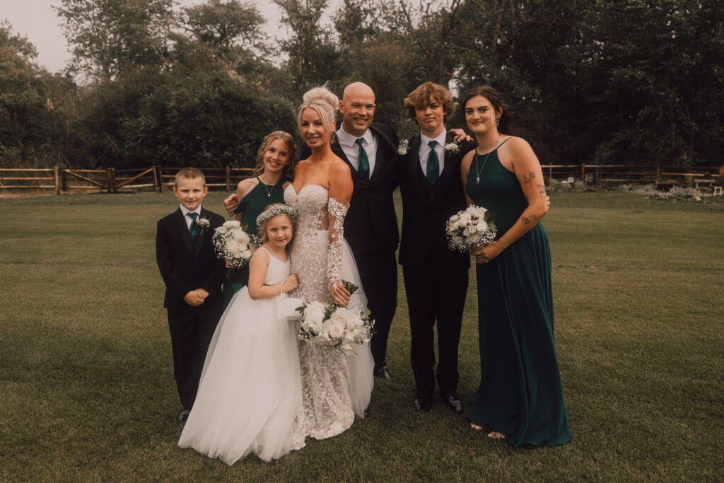 Bride and groom surrounded by their kids 