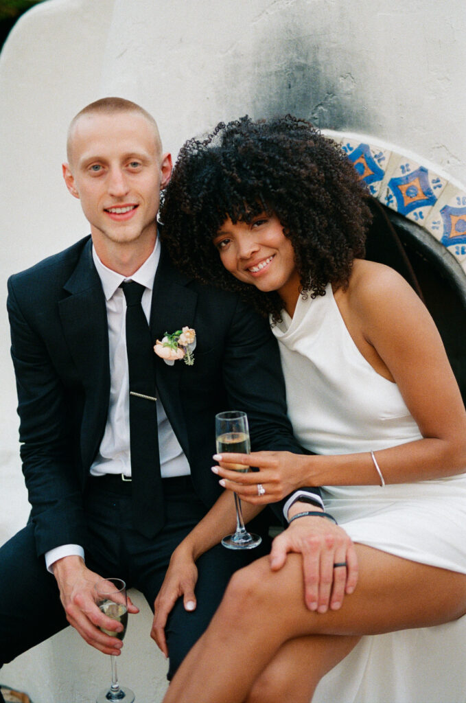 bride and groom drinking champagne