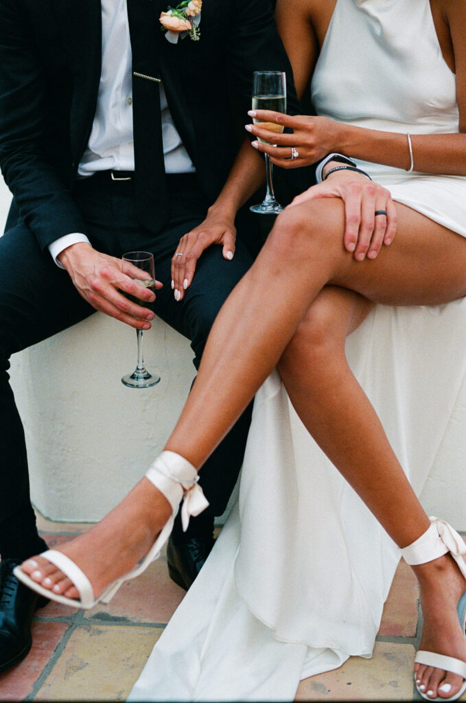 bride and groom drinking champagne