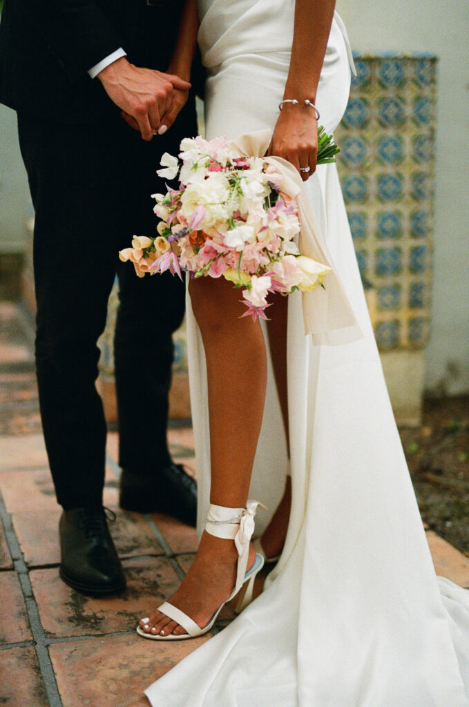 bride and groom close up of feet and bouquet 