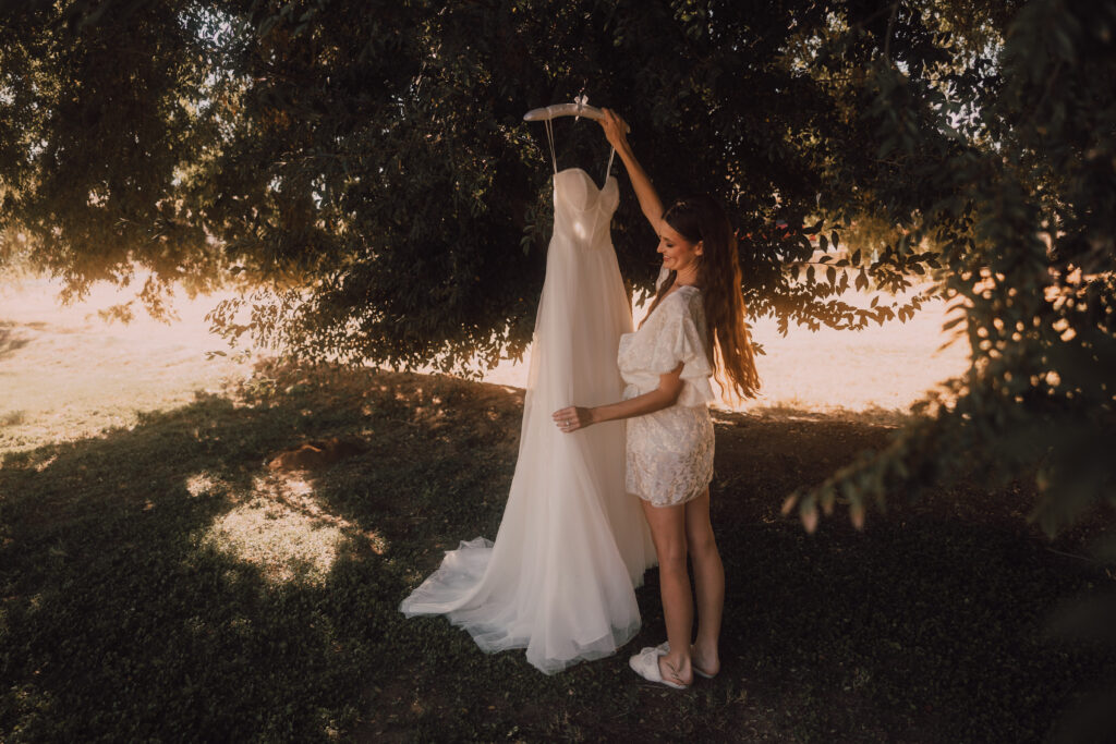 Bride holding wedding dress