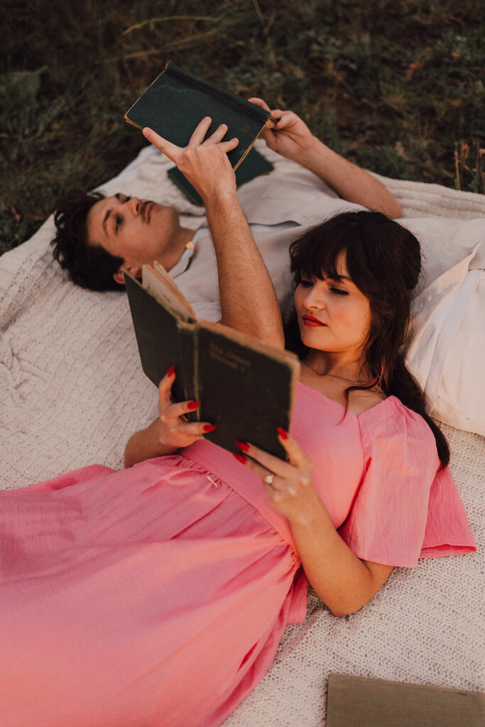 Sunset engagement session in a field with wine and props