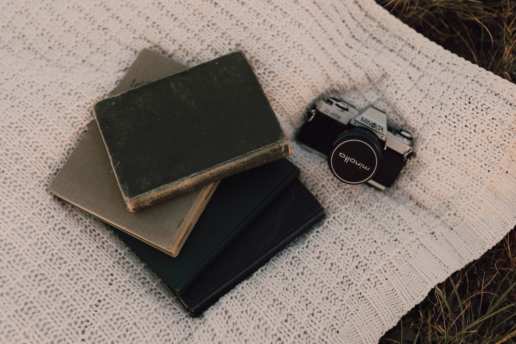 Sunset engagement session in a field with wine and props